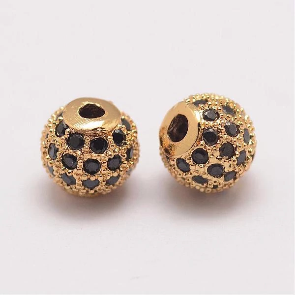 Strasszal díszített arany színű fekete köves cirkónia gyöngy (6mm)
