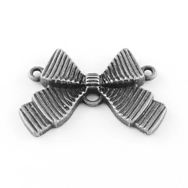 Antikolt ezüst színű masni alakú kapcsolóelem